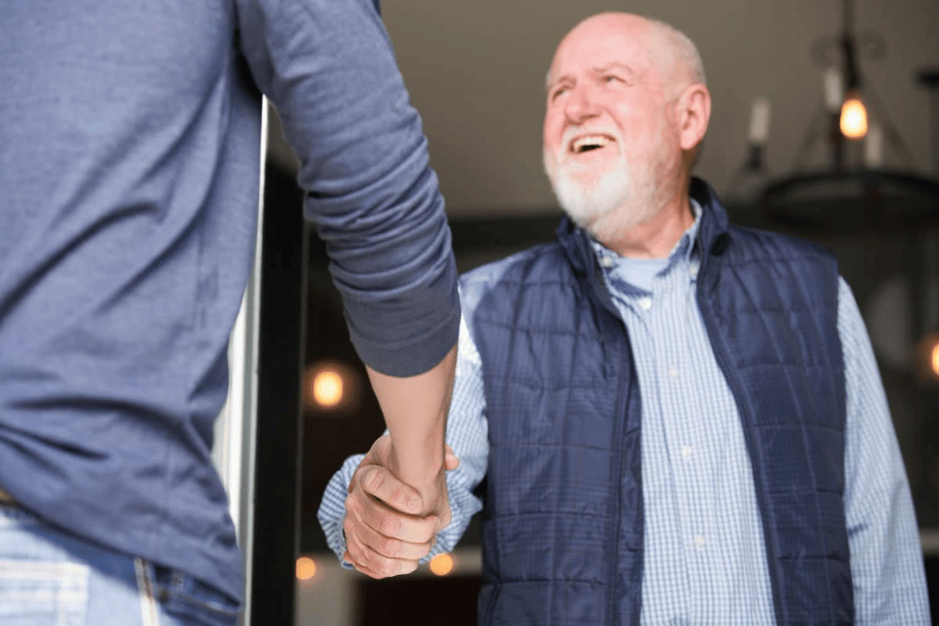 Church-Revitalization-Health-Growth-Discipleship_The-Malphurs-Group_Greeter-Shaking-Hands (1) Image of church greeters from The Malphurs Group, Church Consulting organization helping with Church Revitalization, Health, Growth, and Discipleship Resources